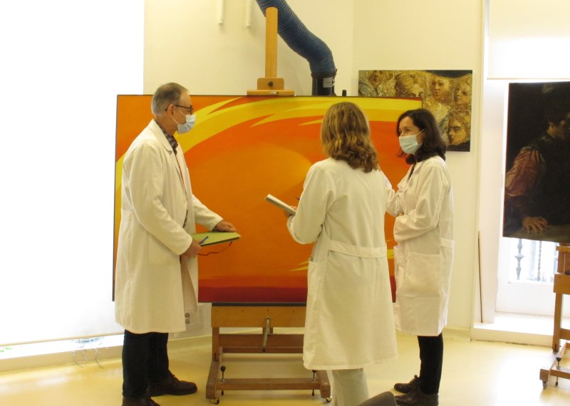 Detail of the restoration team studying the painting "From the Plains II"